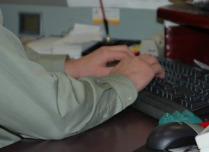 Male book editor typing at keyboard